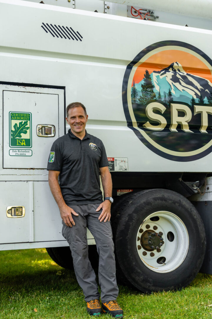 Man standing beside a large branded truck.